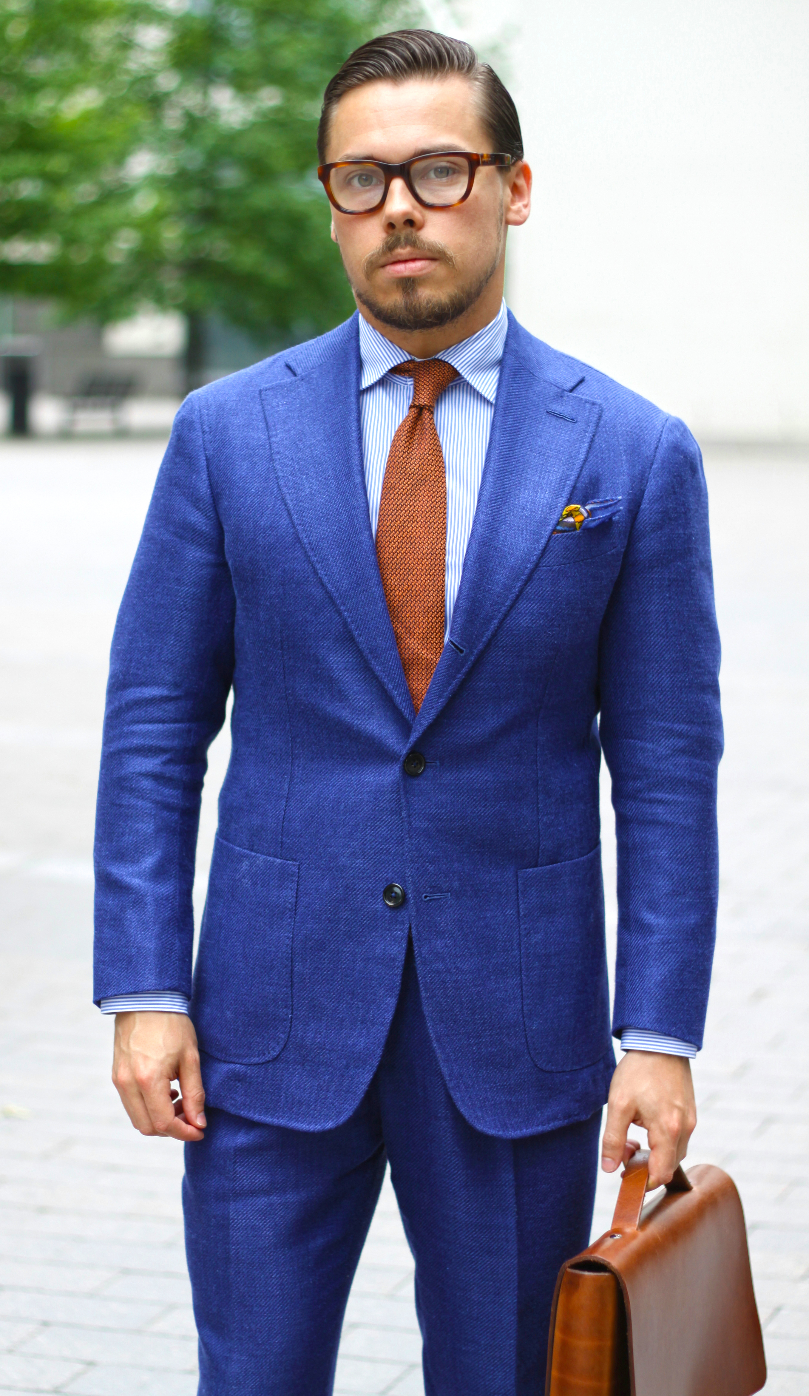 Blue Suit matched with an orange tie