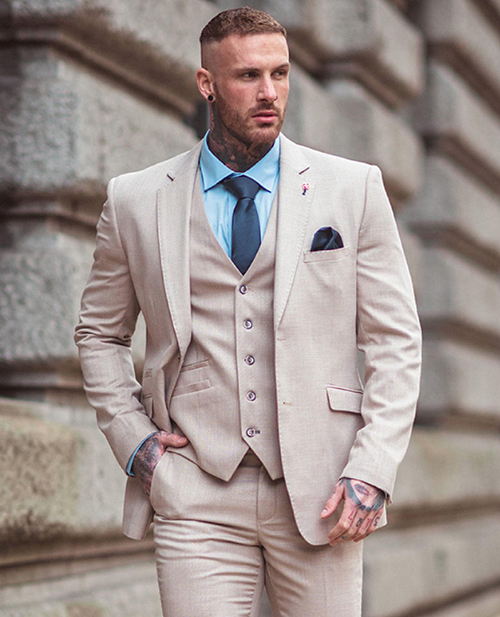 beige suit with a pale blue shirt