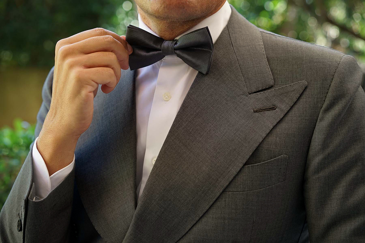 dark grey suit with a black bow tie