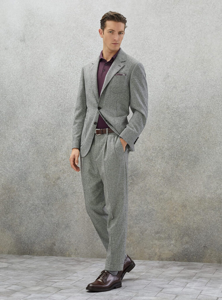 grey houndstooth suit, burgundy polo t-shirt, and brown derby shoes