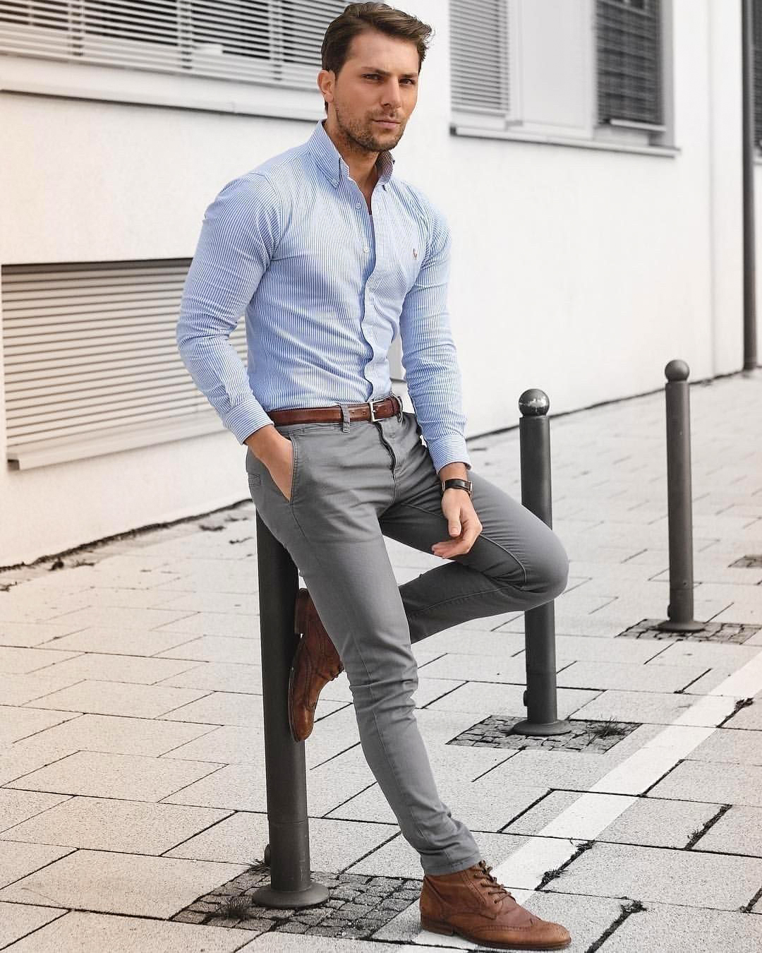 wearing light-blue shirt, brown shoes, and grey pants