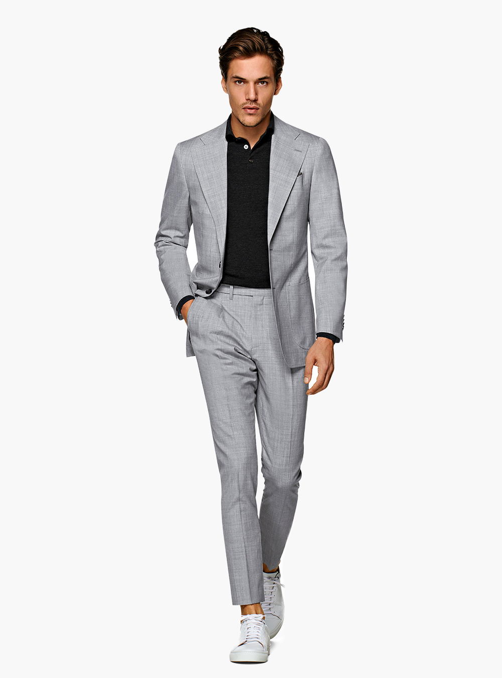light grey suit, black polo shirt, and white sneakers