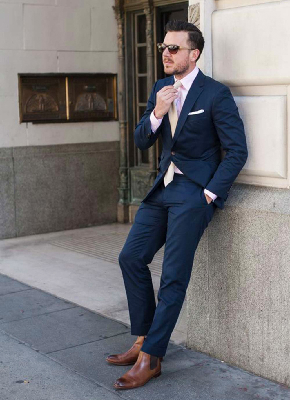 navy blue suit, light pink shirt and brown chelsea boots