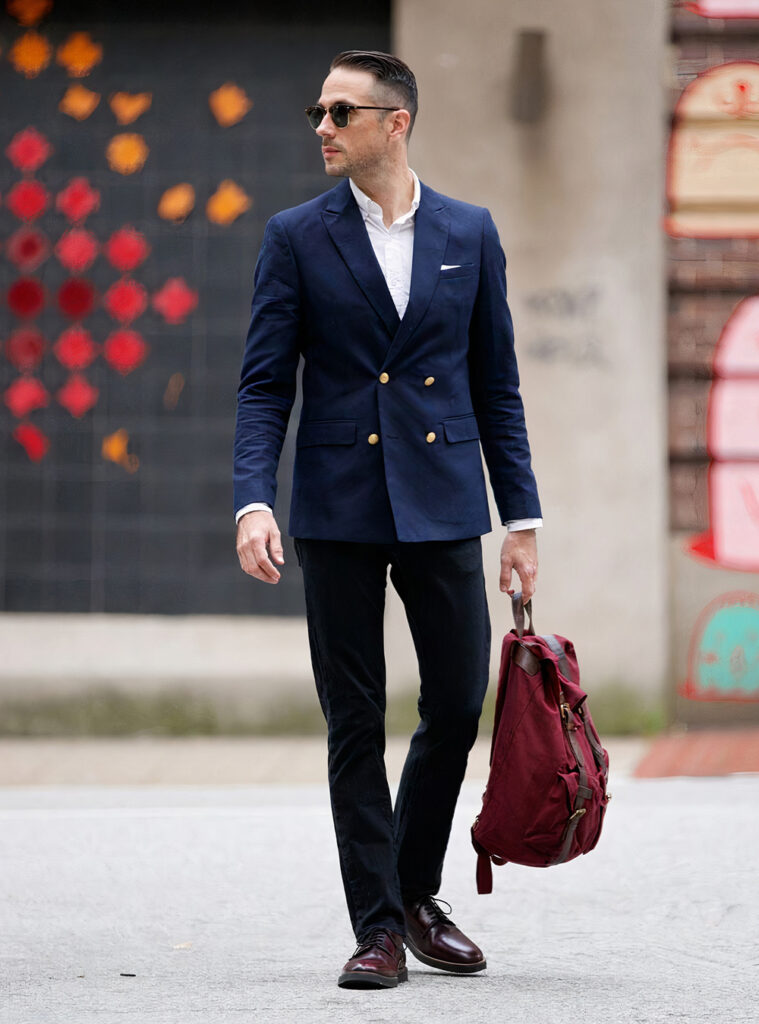 navy double-breasted blazer, white shirt, black jeans, and brown derby shoes