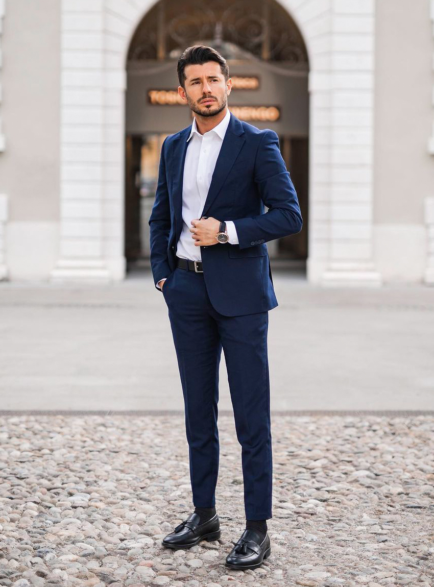 navy suit, white dress shirt, and black tassel loafers
