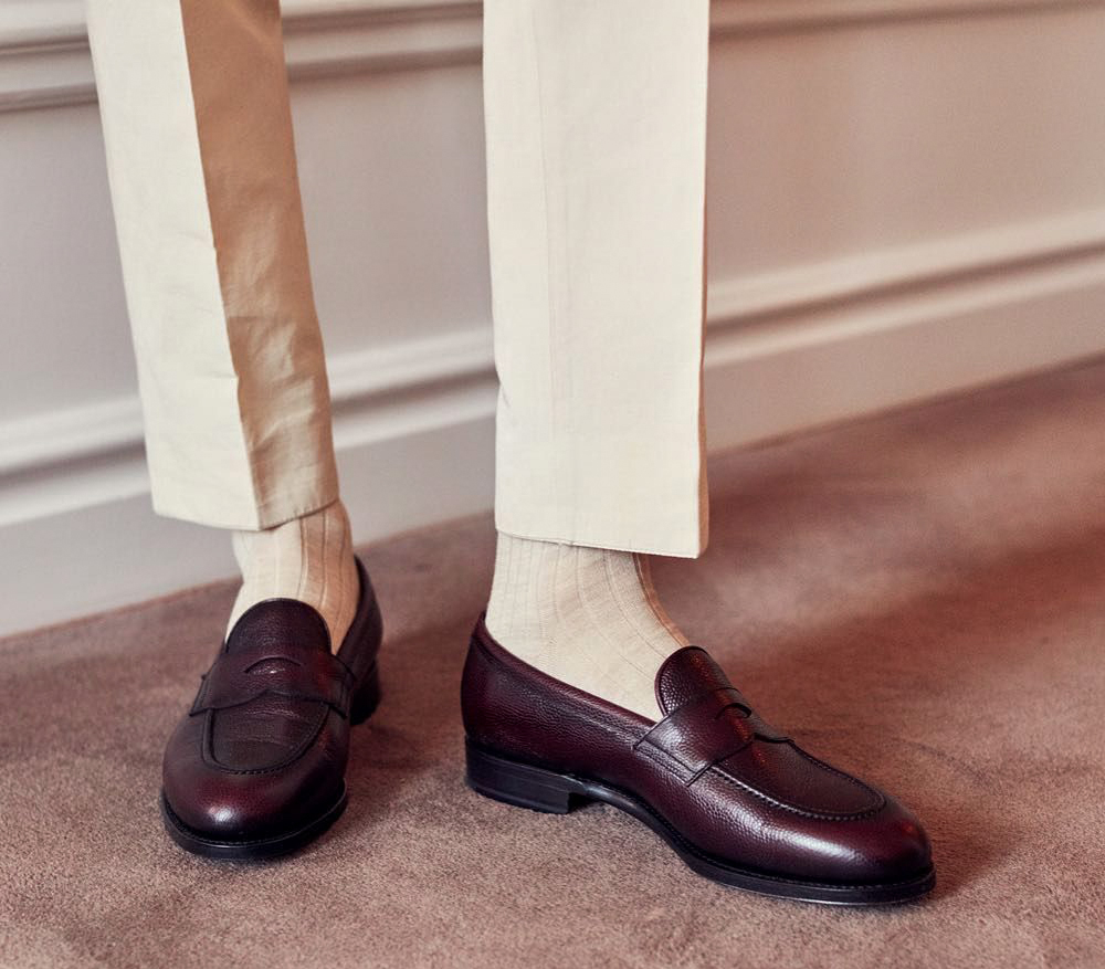 wearing burgundy loafers and beige pants