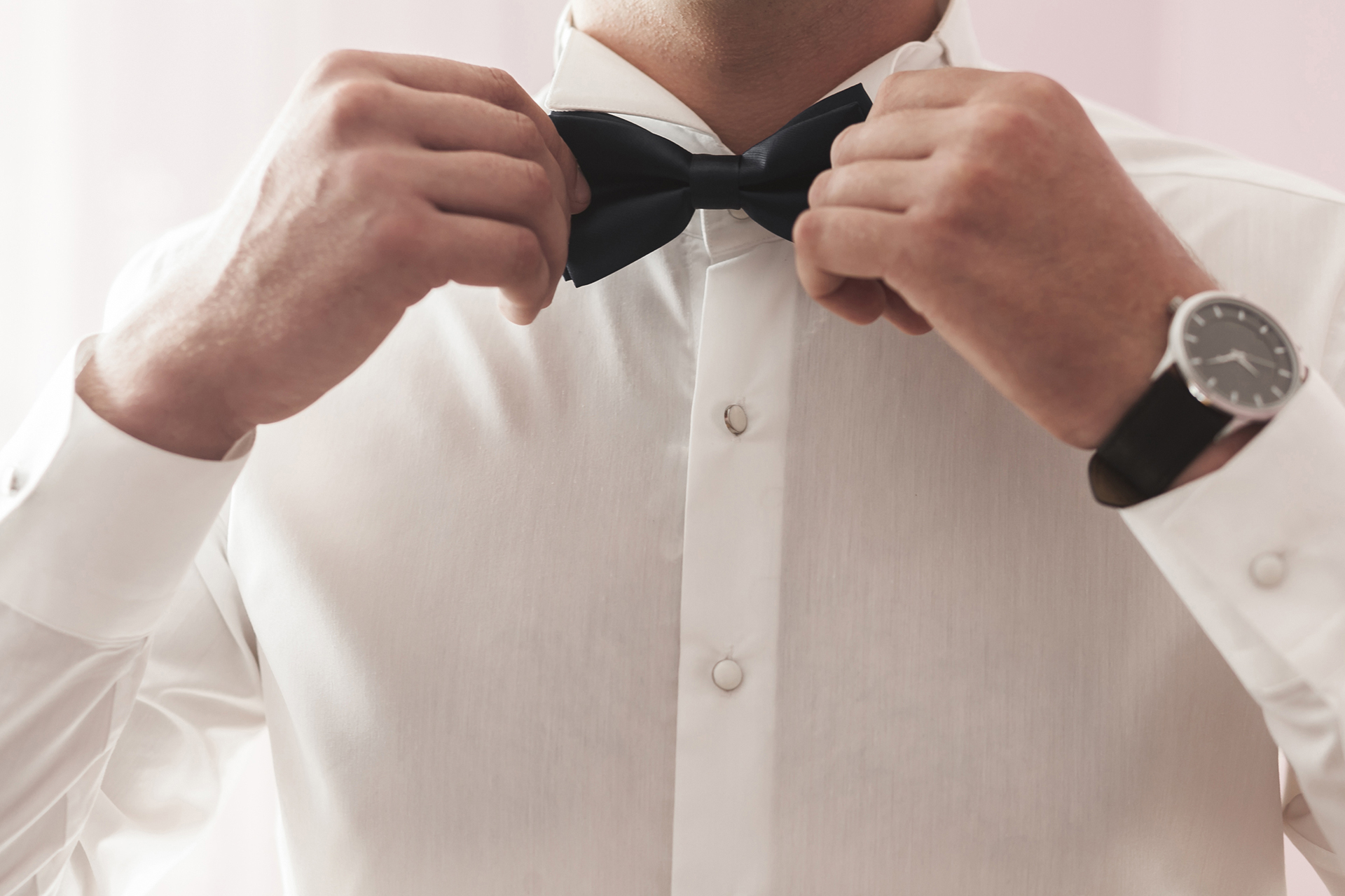wearing a simple white dress shirt with a bow tie